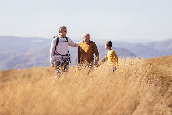 Three generations of family hiking together in the autumn.